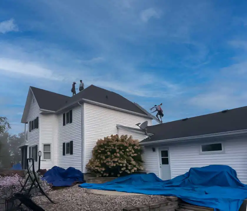 South Central Wisconsin Roofing Crew On Top Of A Two Story White Home