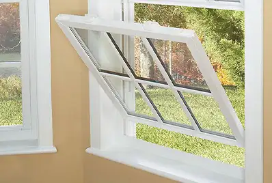 Close up of an open window facing a yard.